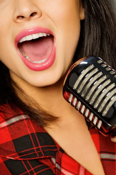 Stock image Woman - singer with retro microphone