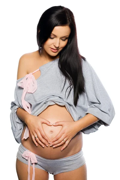 Mulher grávida segurando barriga exposta — Fotografia de Stock