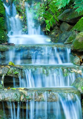 Beautiful veil cascading waterfalls, mossy rocks clipart