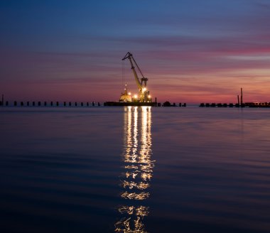 Floating crane at night clipart