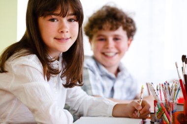 Girl and boy doing homework clipart