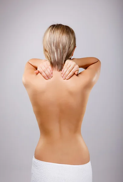 Woman massaging pain back — Stock Photo, Image