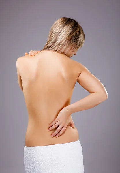 Young Woman Massaging Pain Back Gray Background — Stock Photo, Image