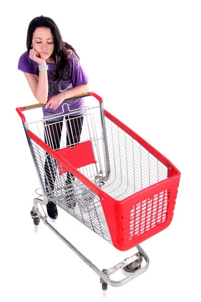 Unhappy girl with shopping cart — Stock Photo, Image