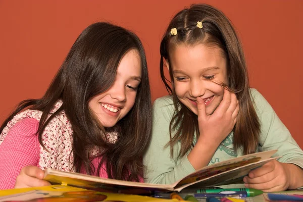 Girls reading book in classroom — Stock Photo, Image