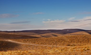 The Kazakhstan steppes, hills, plains, roads, the blue sky clipart