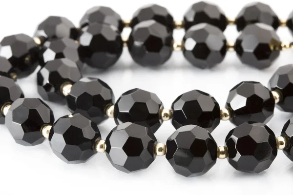 Black beads on white — Stock Photo, Image