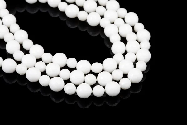 White beads on black — Stock Photo, Image