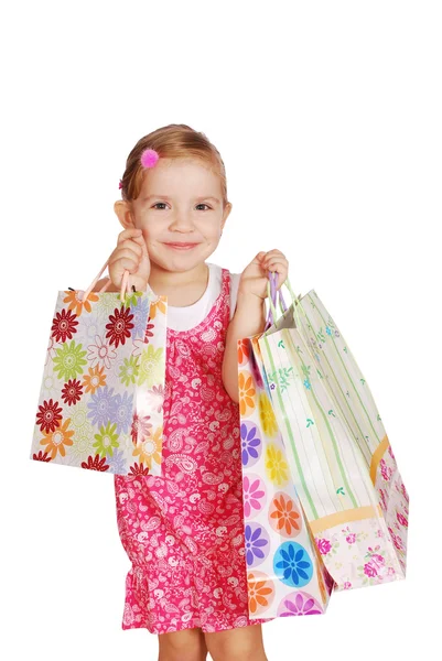 Boldog kis lány a bevásárló szatyrok — Stock Fotó