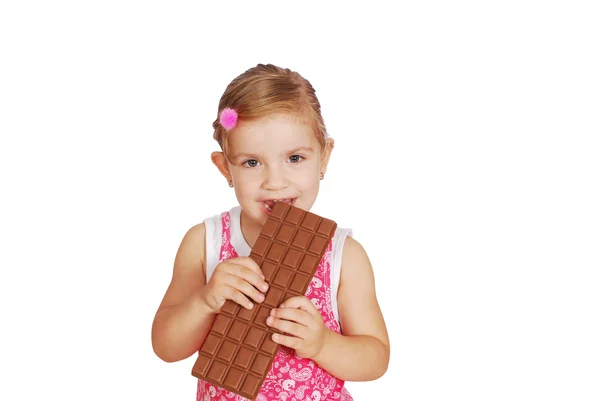 Little girl eat large chocolate — Stock Photo, Image
