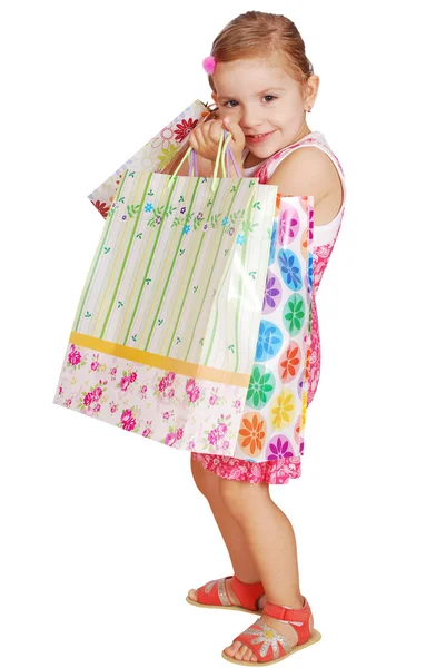 Küçük kız holding alışveriş torbaları — Stok fotoğraf