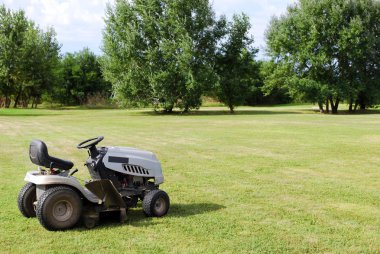 Lawn mower on field clipart