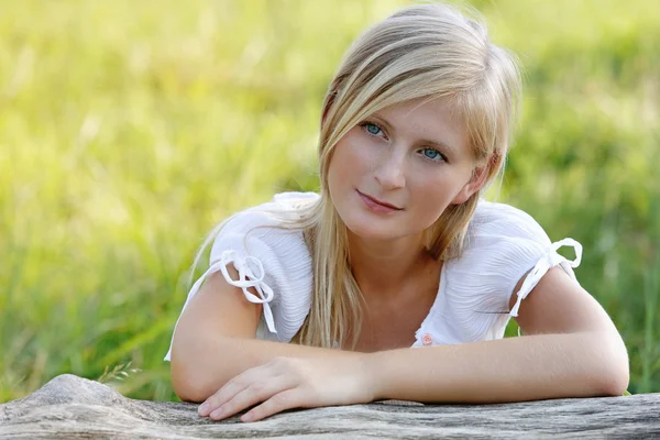 stock image Beautiful woman in the logs