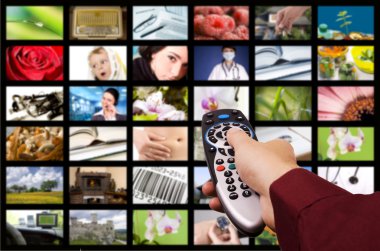 Close up of a hand holding a remote control with a television concept. clipart