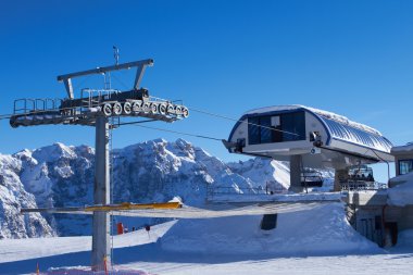 Ski lift in winter at Italian Dolomites clipart