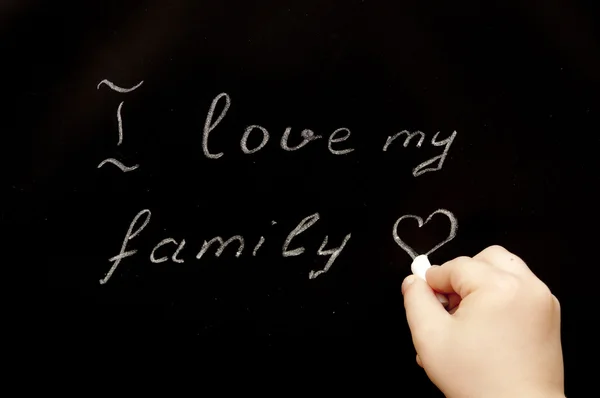 stock image The child writes on a black board