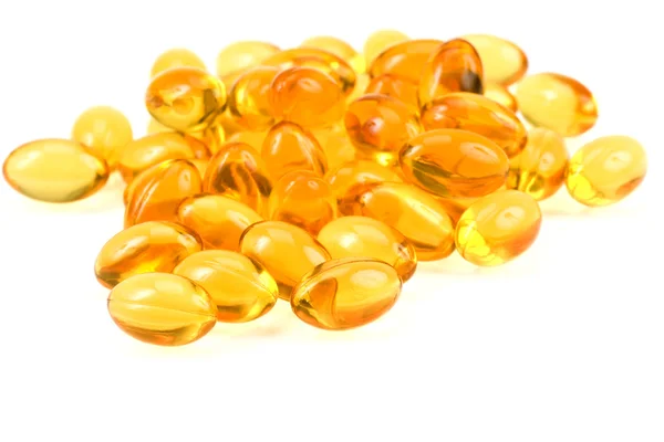 Pílulas de óleo de peixe ouro transparente close-up — Fotografia de Stock
