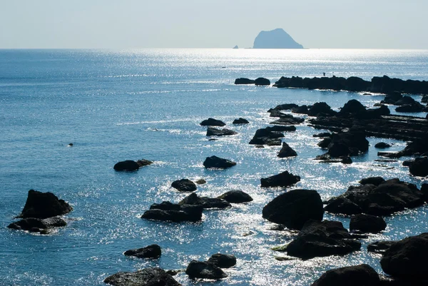 Rocky seashore with sun light reflection — Stock Photo, Image