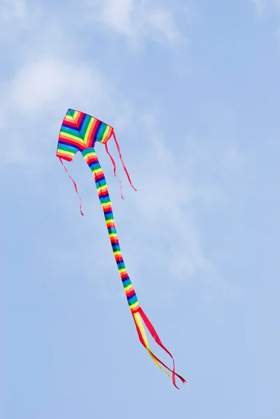 stock image Colorful kite flying in blue sky.