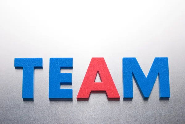 Team word on metal background, part of a series of business words — Stock Photo, Image