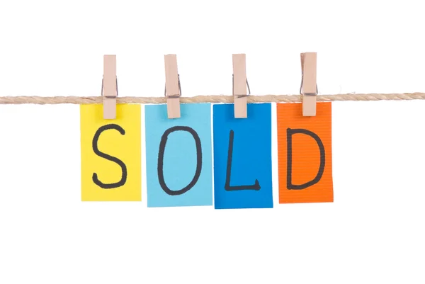 Sold, Colorful words hang on rope — Stock Photo, Image