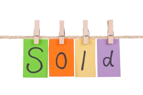 Sold, Colorful words hang on rope — Stock Photo, Image