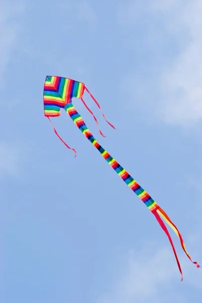 Stock image Colorful kite flying in blue sky.