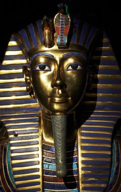 Tutankhamen's golden mask in mystic light clipart