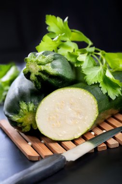 Green zucchini and half with parsley clipart