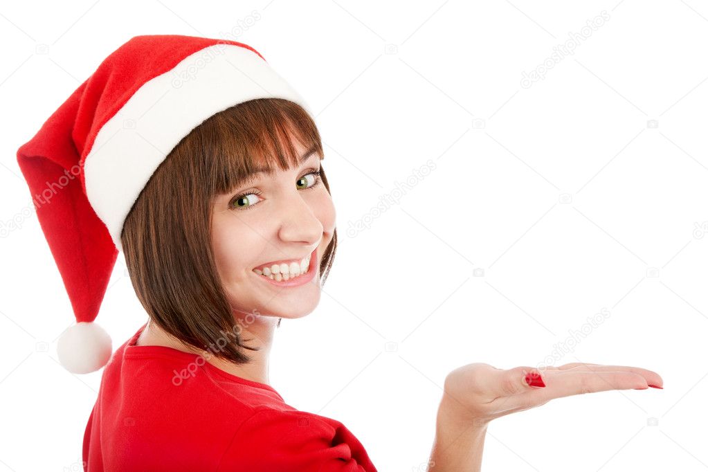 Smiling woman in Santa hat presenting your product