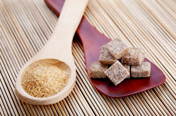 stock image Wooden spoons with different kinds of brown sugar