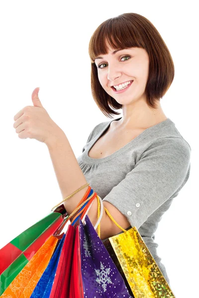 Žena s nákupní tašky tvoří jí palce — Stock fotografie