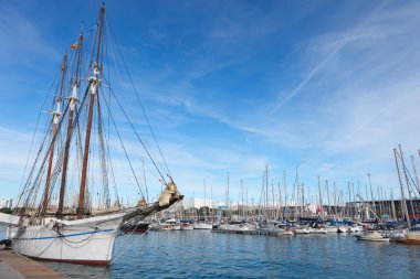 Sailboat in Barcelona harbor. clipart