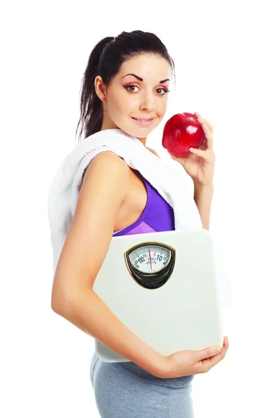 Dívka s váhy a apple — Stock fotografie