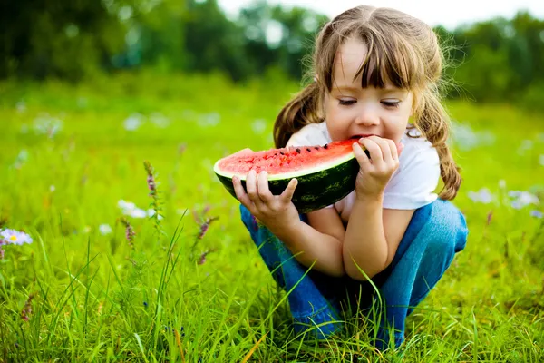 Meisje eten watermeloen Stockafbeelding