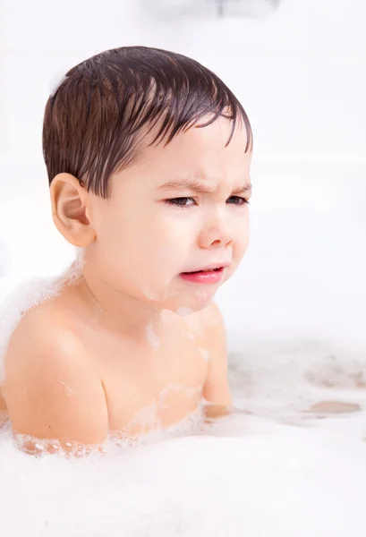 Displeased boy taking a bath — Stock Photo, Image