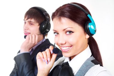 Beautiful woman and a young man working in the call-center (focus on the woman) clipart