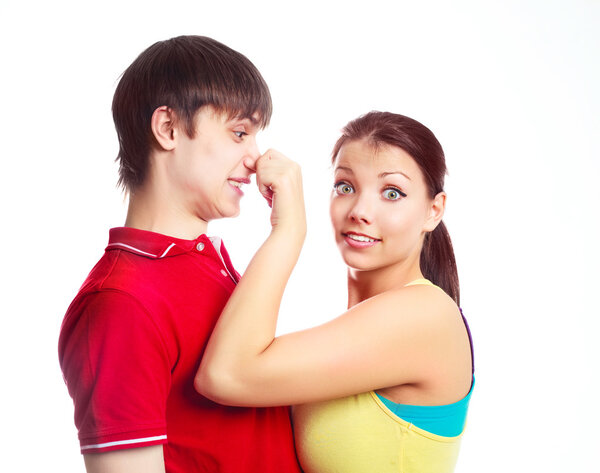 Teenage couple fooling around, a girl pulling a boy by the nose