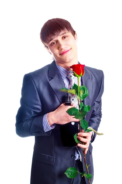 Schöner Junger Mann Mit Roter Rose Und Einer Flasche Brandy — Stockfoto