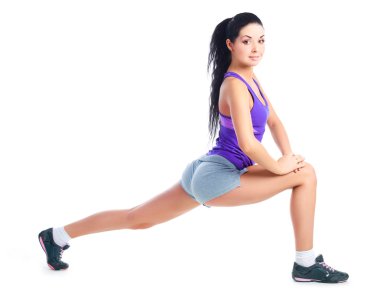 Beautiful young brunette woman stretching the muscles of her legs clipart