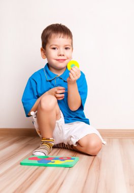 Boy plaing with toy clipart