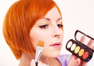 woman applying rouge clipart