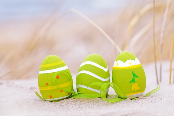 Easter decorated eggs on sand — Stock Photo, Image