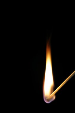 Match flame on black background. clipart