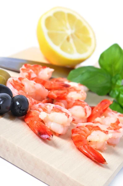 Shrimps, olives, lemon, and basil on board isolated on white bac — Stock Photo, Image