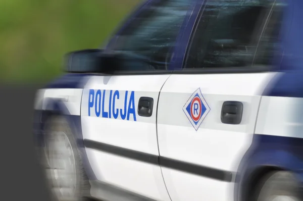 Carro da polícia em movimento embaçado — Fotografia de Stock