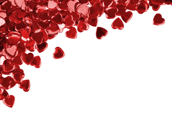 Confettis cœurs rouges sur fond blanc — Photo