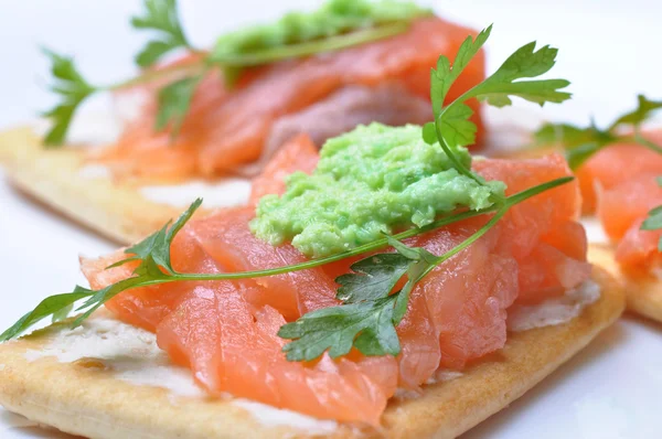 Smoked salmon with wasabi on cracker isolated