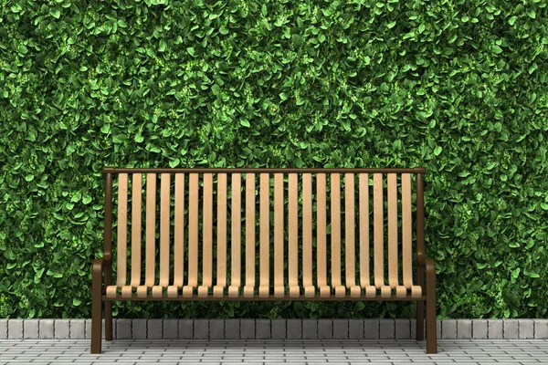 stock image Wooden bench in front of green hedge in the park