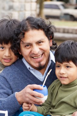 Latin family sitting in the street clipart